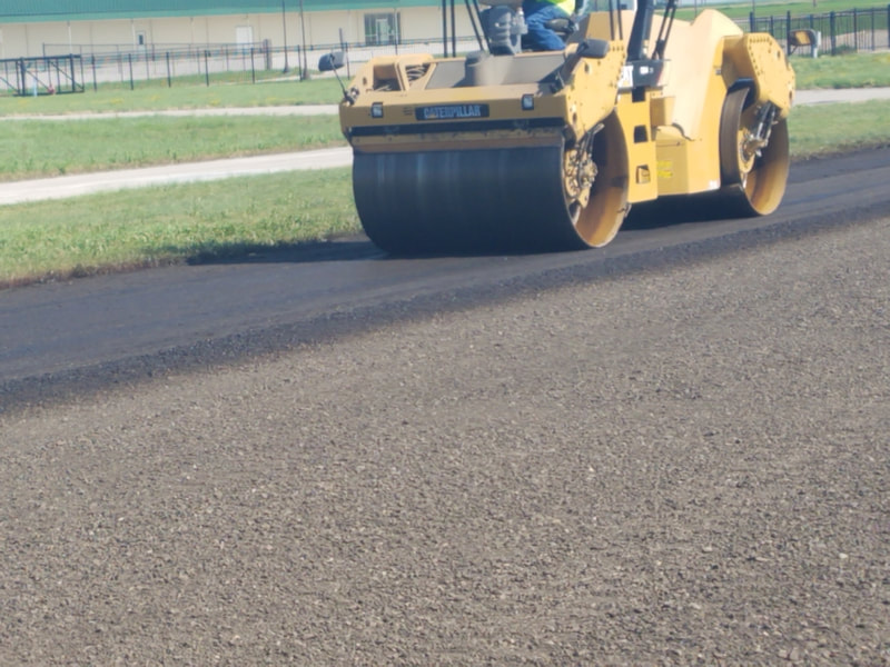 Roller compacting treated millings